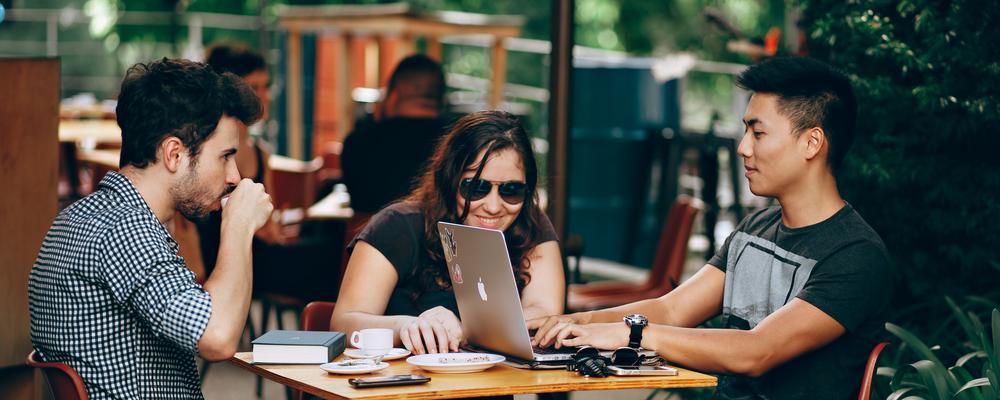 Students at a café abroad, studying together.