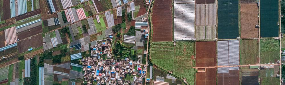 Aerial view of agricultural plots of land under cultivation in an agricultural town. Mengzi, Yunnan Province, China