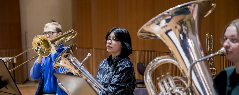 Several persons with brass instruments