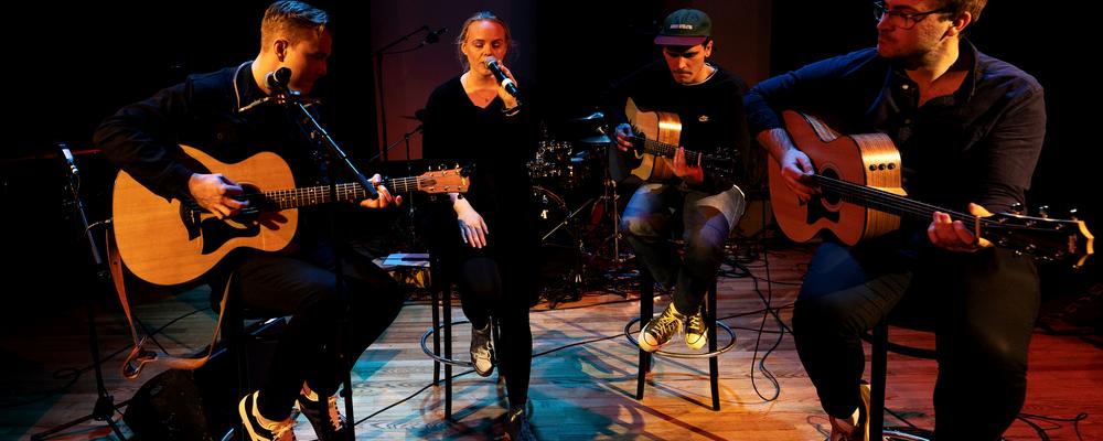 Several persons with guitars, one singing