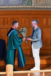 Dean Dick Stenmark is handing over flowers to Miroslaw Staron, who recently achieved the title Excellent Teacher.