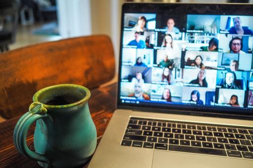 Tea cup in front of a laptop, where a zoom meeting is ongoing