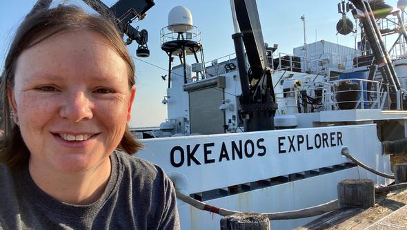  Rhian Waller next to the research vessel Okeanos Explorer