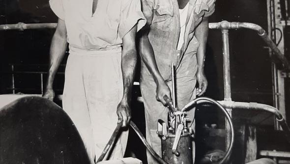 Gruvarbetare smörjer en klassificeringsmaskin i gruvan (1956)