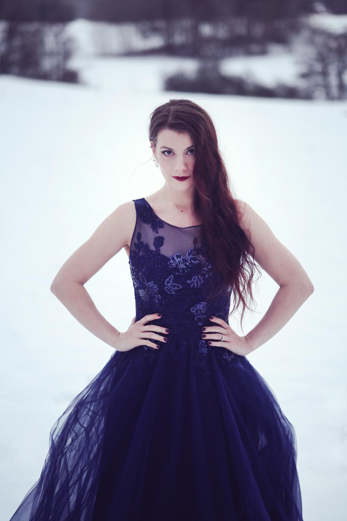 Portrait of Linnéa Sjösvärd in a fine dress in a snowy landscape.